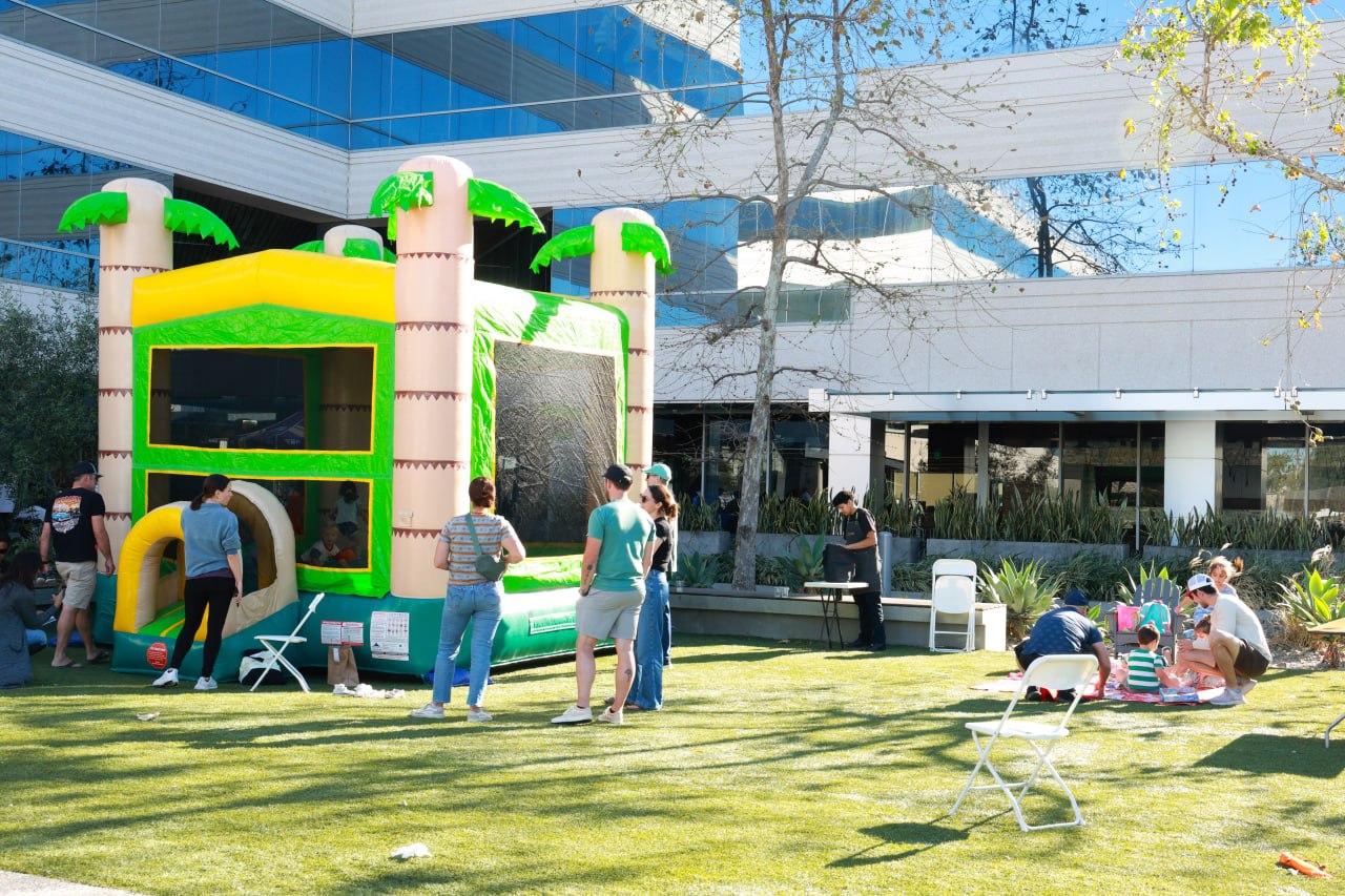 Jungle Jamboree bounce house on the lawn at the FIT4MOM Grand Reopening